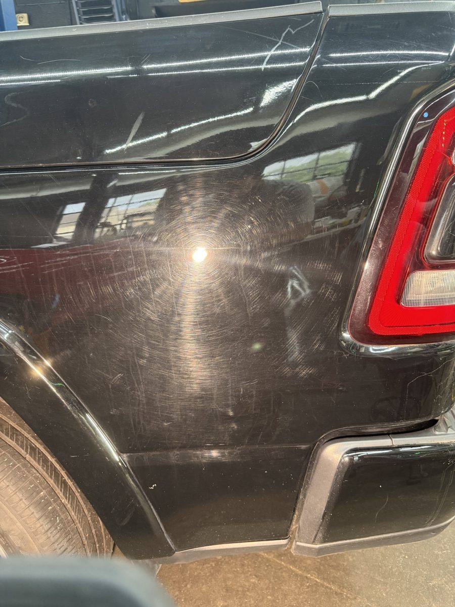 Before: black truck rear panel covered in swirl marks and wash scratches